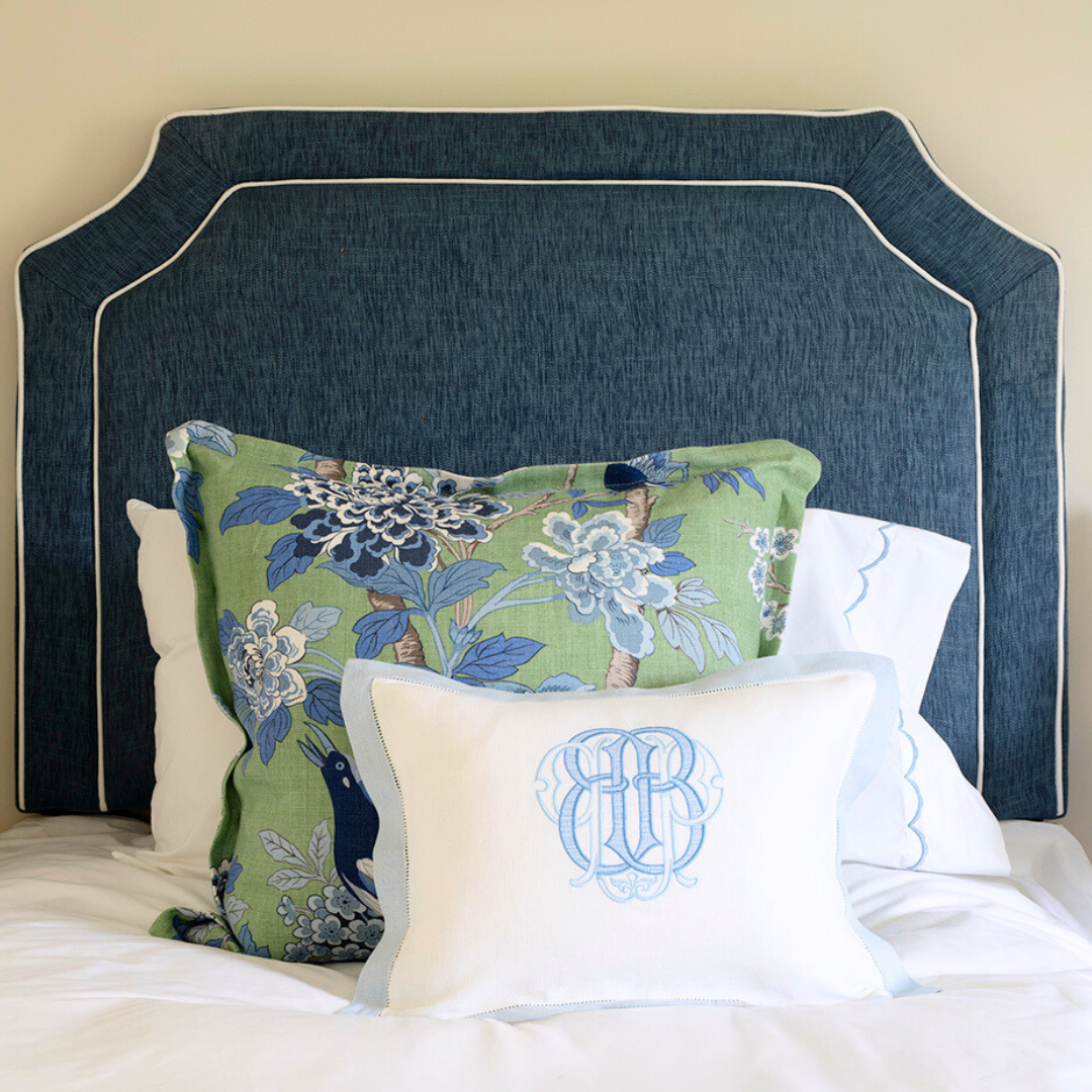 Monogrammed Linen boudoir pillow sham with a light blue hemstitch border. Displayed on a bed with blue headboard and GP & J / Lee Jofa Hydrangea Bird decorative pillow.