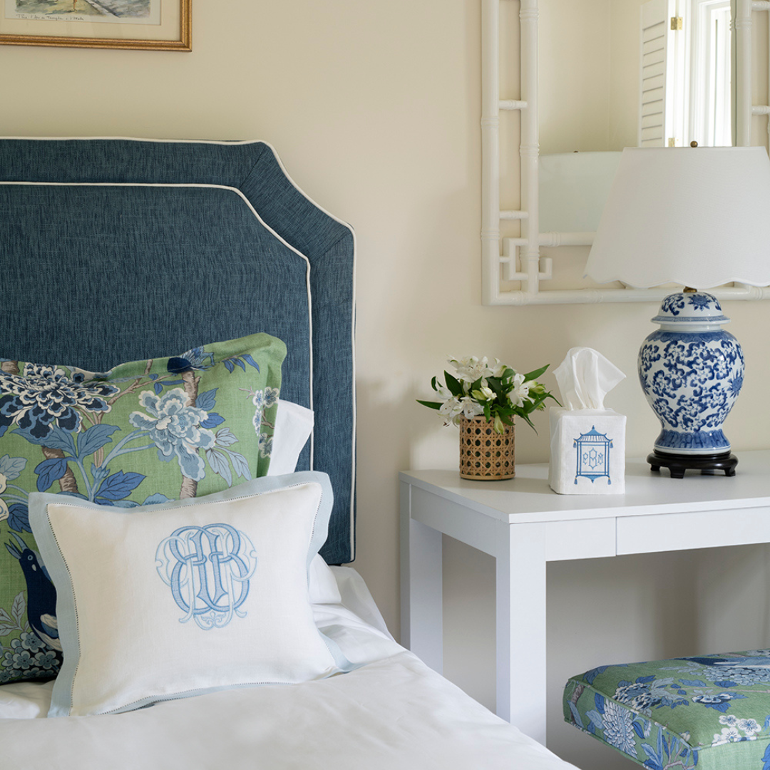 Monogrammed Linen boudoir pillow sham with a light blue hemstitch border. Displayed on a bed with blue headboard and GP & J / Lee Jofa Hydrangea Bird decorative pillow.