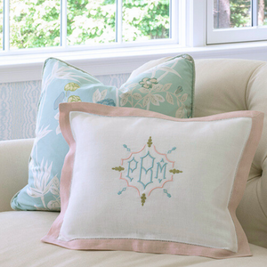 White linen boudoir pillow sham with a 1 " pink linen hemstitch border and monogrammed with shuler studio monogram and the initials PBM. Featured on an ivory loveseat from Hickory Chair as well as two decorative pillows with  Scalamandre chinoiserie fabric. 